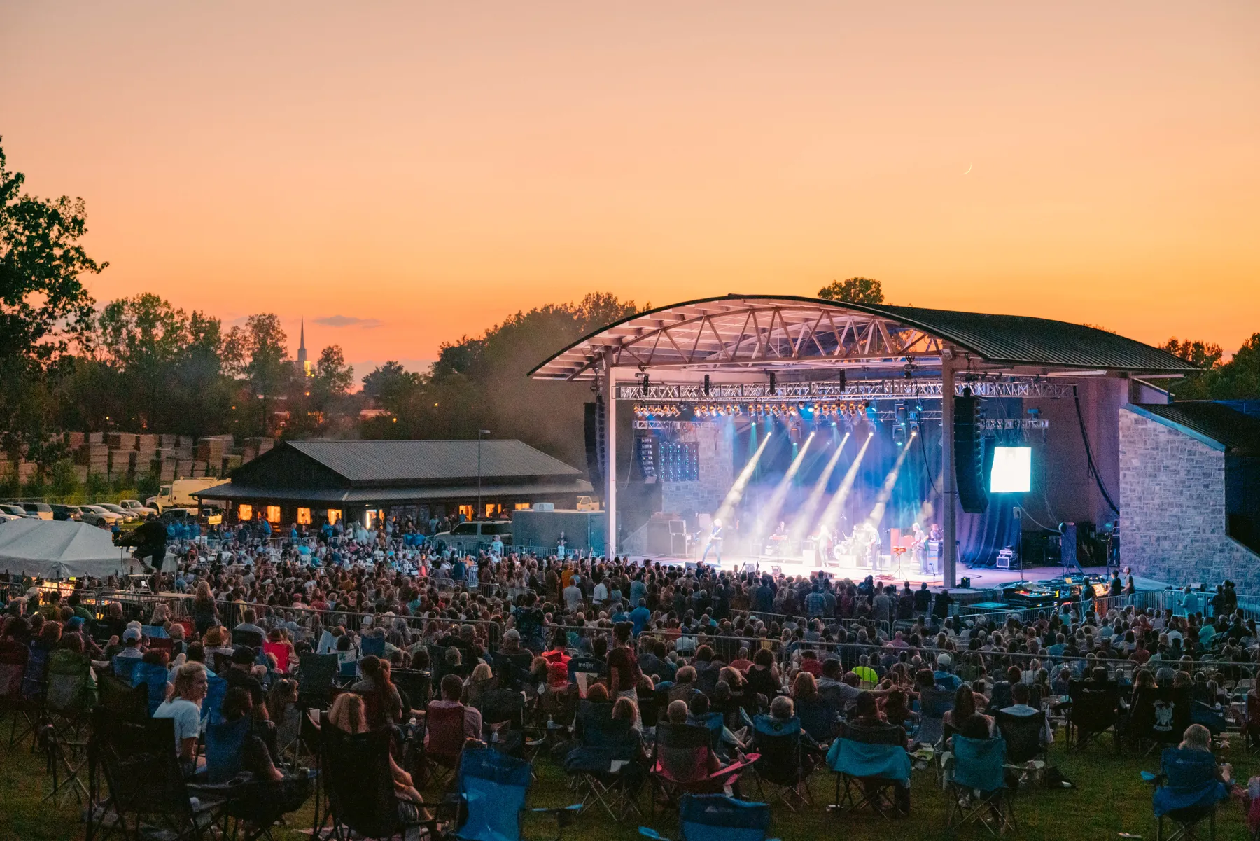 A crowd enjoys Beaver Dam Amphitheater at sunset.