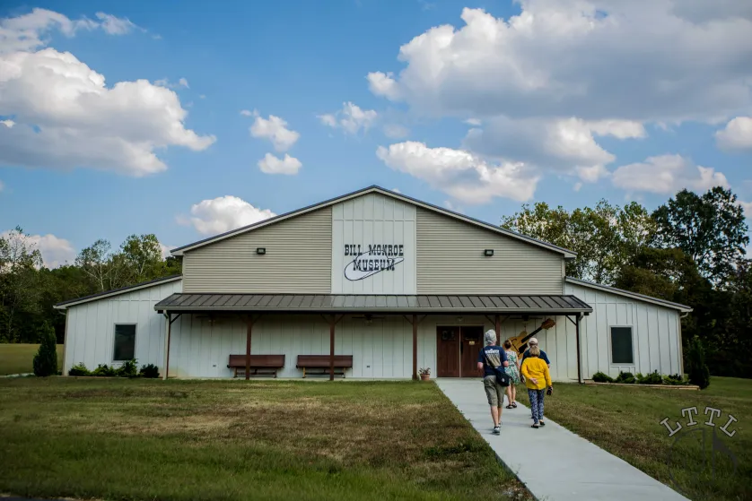 The Bill Monroe Museum, a metal pole barn in a sunny field.