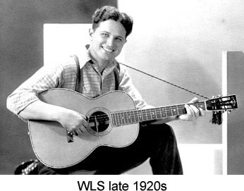 A black and white portrait of Bradley Kincaid with his guitar.