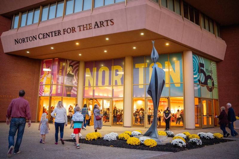 The exterior of the Norton Center for the Arts features colorful window art