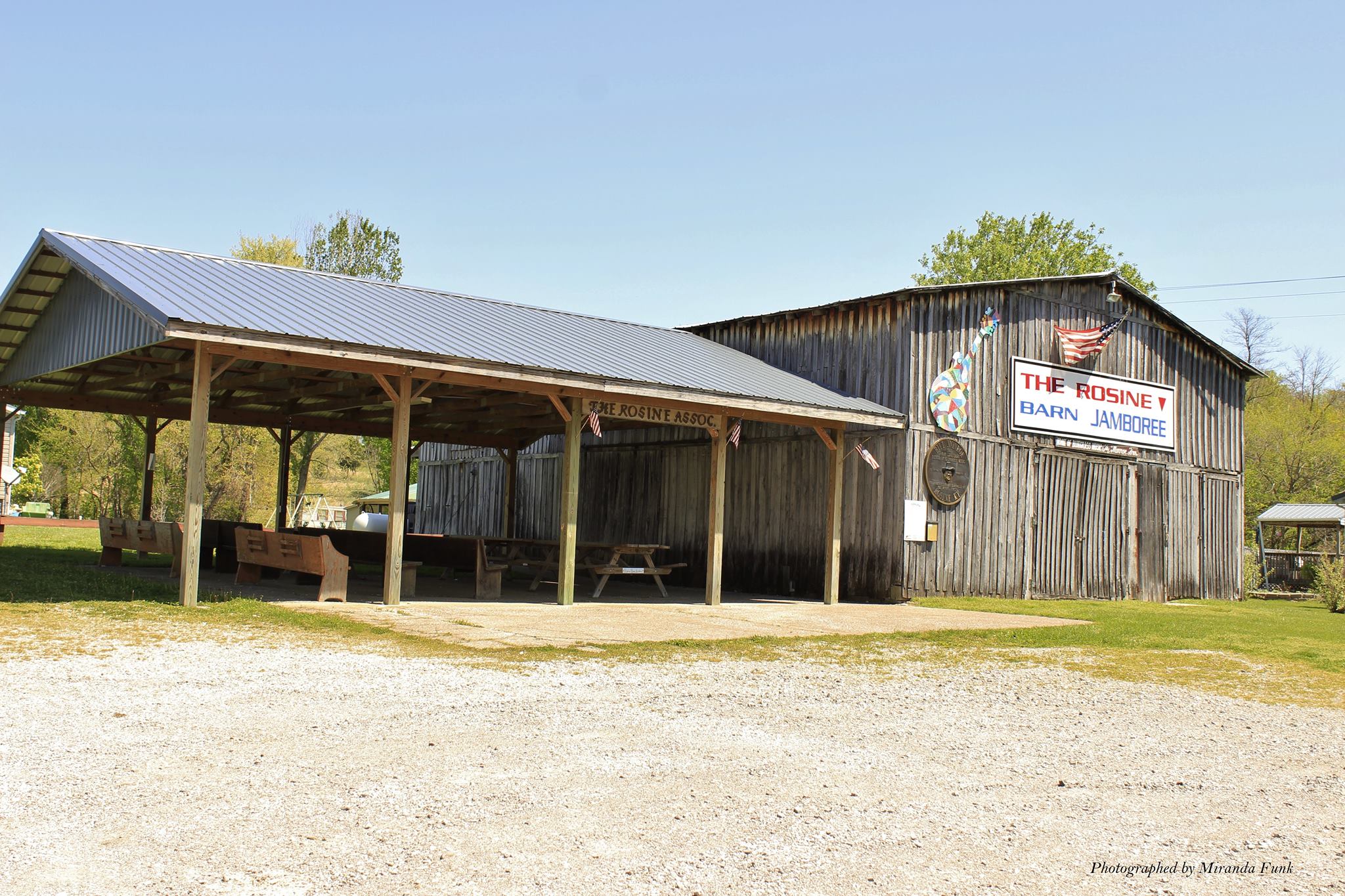 The exterior of a weathered barn, renovated with a pavilion